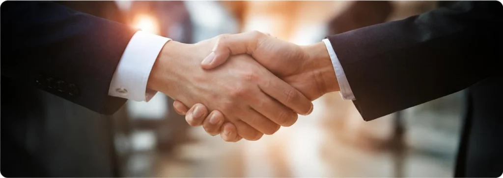 Business professionals shaking hands in a partnership meeting