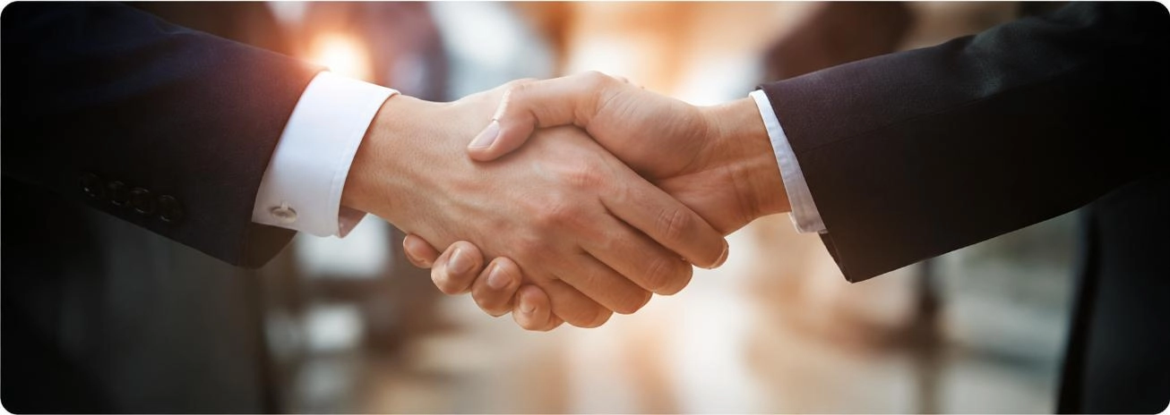 Business professionals shaking hands in a partnership meeting